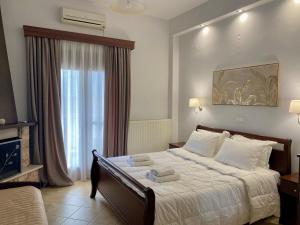 Posteľ alebo postele v izbe v ubytovaní Ξενώνας Ρόδον