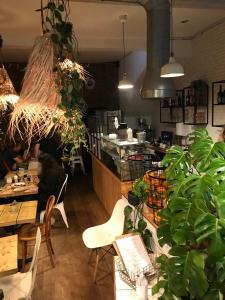 a restaurant with a table and chairs and plants at Funky London Studio, Comfort Meets Style in London