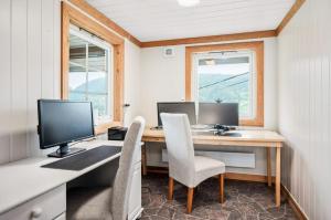 a home office with a desk with two monitors and chairs at Historic Farm With Panoramic Views In Gudbrandsdalen in Favang