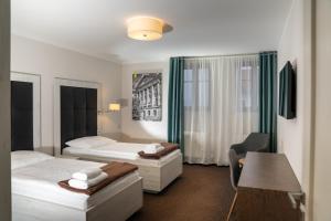 Łóżko lub łóżka w pokoju w obiekcie Hotel Grunt
