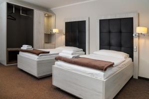 Łóżko lub łóżka w pokoju w obiekcie Hotel Grunt