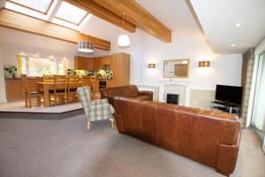 a living room with a couch and a dining room at Loch Rannoch Highland Club in Kinloch Rannoch +40 photos