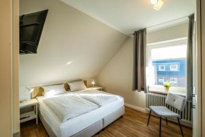Postel nebo postele na pokoji v ubytování Haus Am Anker Wohnung 7