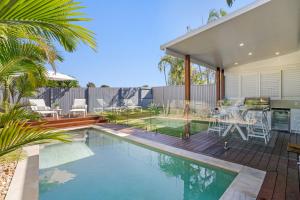 a swimming pool in a backyard with a house at Burleigh Getaway in Gold Coast