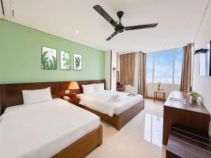 Postelja oz. postelje v sobi nastanitve Doha Central Bliss Danang Hotel by Haviland