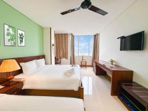 Postelja oz. postelje v sobi nastanitve Doha Central Bliss Danang Hotel by Haviland