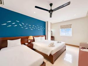 Postelja oz. postelje v sobi nastanitve Doha Central Bliss Danang Hotel by Haviland