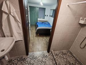 a small bathroom with a bed and a shower at Silver Apartments in Bogács +76 photos