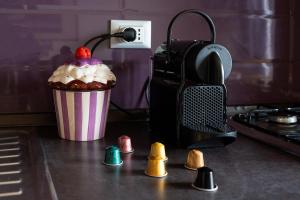 a cup of ice cream and a camera on a counter at Vatican Charm Retreat in Rome +25 photos
