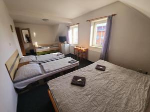 Postel nebo postele na pokoji v ubytování Penzion u Martina