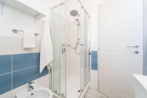 a bathroom with a shower and a sink at Villaggio Residence Emmesse Appartamento Standard in Mandaradoni +19 photos
