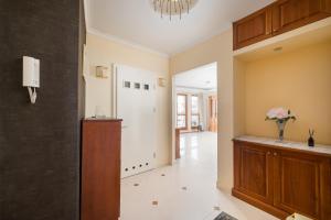 a living room with a hallway with a vase of flowers at Royal Wilanów Spacious Apartment by BookingHost in Warsaw +24 photos