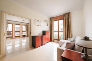 a living room with a couch and a table at Royal Wilanów Spacious Apartment by BookingHost in Warsaw