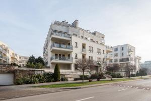 a large white building on the side of a street at Royal Wilanów Spacious Apartment by BookingHost in Warsaw