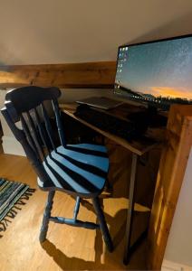 una sedia nera e blu seduta di fronte a una scrivania con un computer di Cosy Cottage Stay Book & Unwind a Penrith Altre 16 foto