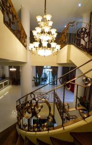 a staircase in a house with a chandelier at Ongville Hotel & Events Place in Candelaria