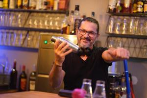 a man standing at a bar holding a glass at Madgic Loft in Épinal