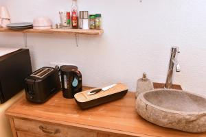 a bathroom counter with a sink and a faucet at Gite See You Soon - Studio Surf in Colmar +26 photos