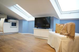 a living room with a flat screen tv and a couch at casa vacanze LE PLEIADI in Diano Marina +9 photos