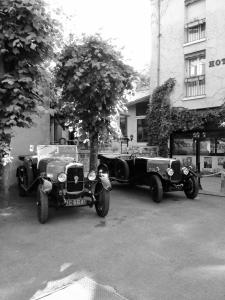 two old cars parked next to each other on a street at Hotel Val De Loire in Azay-le-Rideau +41 photos