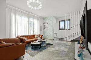 a living room with a couch and a table at Eden Blue Villa by Nomads in Emba