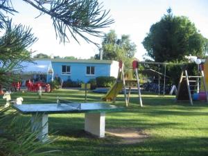 a park with a playground with a slide and swings at Camping 4 étoiles - Piscine - efcfbi in Faverolles-sur-Cher