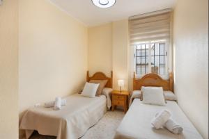 a bedroom with two beds and a window at Sorolla Rota free parking by Staycare in Rota
