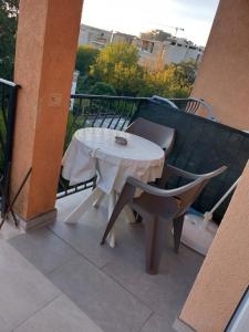 a white table and a chair on a balcony at Guest House Olga in Budva