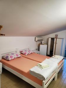 two beds sitting next to each other in a room at Guest House Olga in Budva