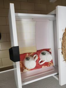 a toy kitchen with two white dishes in a drawer at Guest House Olga in Budva
