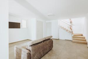 a living room with a couch and a staircase at Marechiaro Room in Vasto