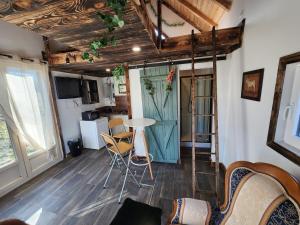a living room with a table and chairs and a kitchen at Chalet de la Comté in Le Thillot