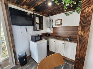 ル・ティヨにあるChalet de la Comtéの小さなキッチン(冷蔵庫、壁掛けテレビ付) +6枚の写真