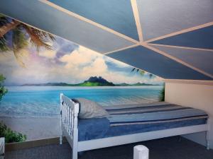 a bedroom with a mural of the beach at Guest House Olga in Budva