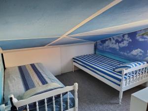 two bunk beds in a room with a blue ceiling at Guest House Olga in Budva