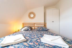 a bedroom with a bed with two towels on it at Charmant Duplex Lumineux in Angers