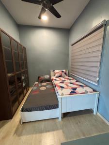 una camera con letto e ventilatore a soffitto di Cozy Condo - Walking distance to National Stadium Bukit Jalil a Kuala Lumpur