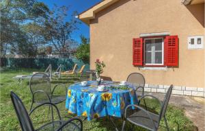 a table with a blue table cloth with flowers on it at Holiday Home Kature Iv in Labin