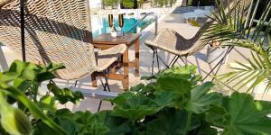a patio with a table and chairs and a pool at New Line Village Apartments in Sunny Beach
