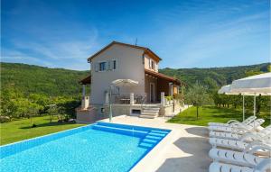 a villa with a swimming pool and a house at Villa Alba in Motovun