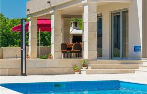 a house with a swimming pool in front of a house at Villa Anzela in Pula