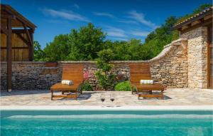 a pool with two benches and two wine glasses at Villa Milica in Pula