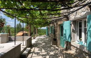 a street in a village with a tree overhead at Casa Zamarija in Labin