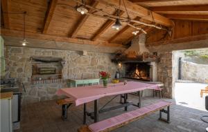 a stone kitchen with a table and a fireplace at Casa Zamarija in Labin