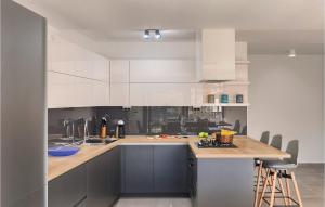 a kitchen with white cabinets and a wooden counter top at Villa Dolcea in Umag