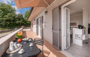 a patio with a table and chairs on a balcony at Lovely Home In Amelia With Kitchen in Amelia