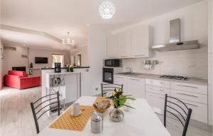 a kitchen and dining room with a table and chairs at Lovely Home In Amelia With Kitchen in Amelia
