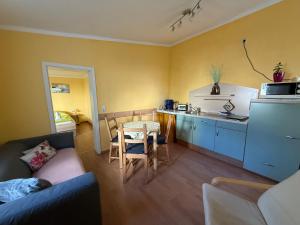 a living room with a couch and a table and a kitchen at Ferienwohnungen Alte Bäckerei in Rostock +14 photos