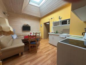 a kitchen and living room with a couch and a table at Ferienwohnungen Alte Bäckerei in Rostock