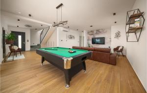 a living room with a pool table and a couch at Stunning Home In Zaboric With Sauna in Zaboric